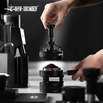 A person skillfully uses a tamper to press coffee grounds into a portafilter for espresso precision, with sleek MHW-3BOMBER tools, including the YU Series Cyclone Needle Distributor WDT Tool, against a dark minimalist backdrop.