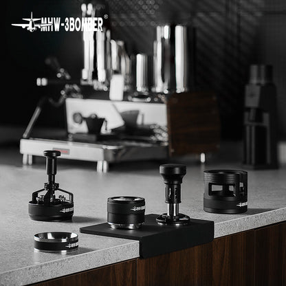 A sleek kitchen countertop displays coffee tools, including tampers and the MHW-3BOMBER YU Series Cyclone Needle Distributor WDT Tool for espresso precision. Coffee grounds are perfectly distributed, with a blurred espresso machine in the background completing this modern coffee setup.