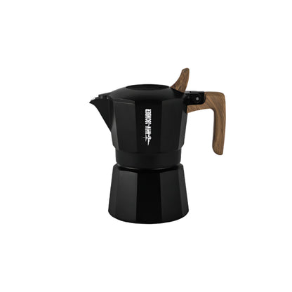 The MHW-3BOMBER Double Valve Moka Pot, a black octagonal stovetop espresso maker with a matte finish and light brown wooden handle, features AMERICAN PRESS in white, a closed lid, and left-pointing spout. Its durable and compatible with most craft coffee stovetops. Capacity: 100ml.