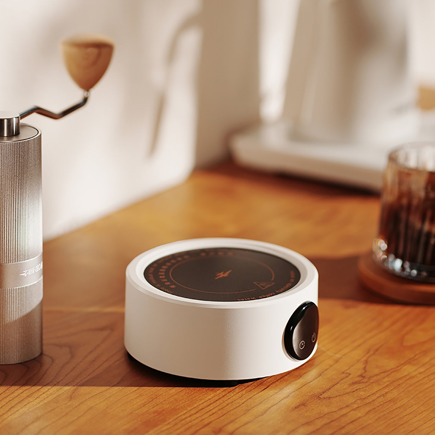 MHW-3BOMBER white mini electric coffee heater with adjustable temperature control on a wooden counter.