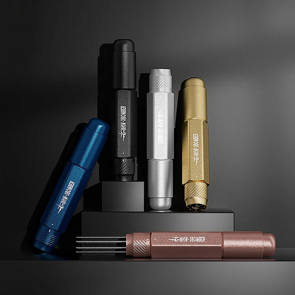 Five multi-colored metal MHW-3BOMBER pens with hexagonal grips sit on staggered platforms. One is open, showing the Lightning Needle Distributor Pro feature. Each pen has Hawkbill and Bomber engraved, emphasizing the efficient grounds distribution system inside.