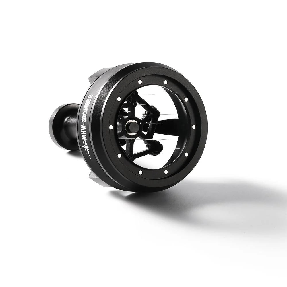 A contemporary black nautical compass with a transparent window and precise movement, resembling the MHW-3BOMBER YU Series Cyclone Needle Distributor WDT Tool. It rests on a white surface, casting a shadow akin to distributed coffee grounds.