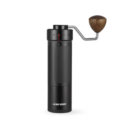 The MHW-3BOMBER Blade R3 Manual Coffee Grinder combines a sleek black cylindrical design with a wooden handle and stainless steel burr, integrating modern and rustic elements. Its measurement markings ensure the perfect brew.