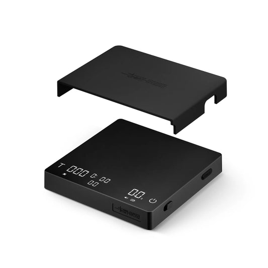 MHW-3BOMBER black Cube Coffee Scale 3.0 Pro Max with a protective cover on a white background. 