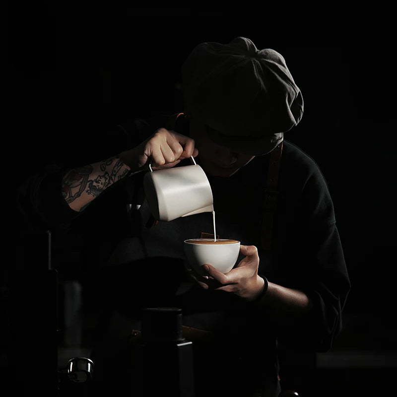MHW-3BOMBER GT Milk Pitcher Glossy in use. Latte art pitcher with unique quadrilateral body and U-shaped spout.