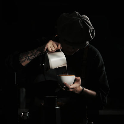MHW-3BOMBER GT Milk Pitcher Glossy in use. Latte art pitcher with unique quadrilateral body and U-shaped spout.