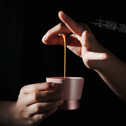 MHW-3BOMBER CERA pink ceramic coffee cup with U-shaped design being filled. Hand washing recommended. 
