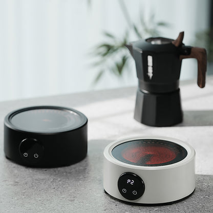 MHW-3BOMBER electric coffee heater in black and white, with moka pot. Compact and portable.