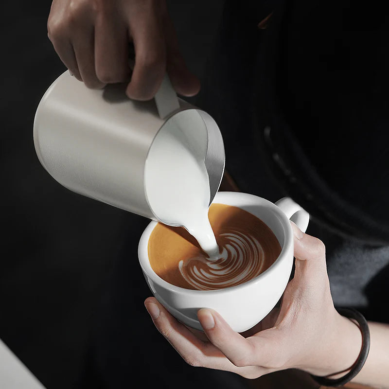 MHW-3BOMBER GT Milk Pitcher glossy white being used to create latte art.