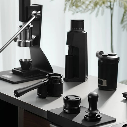 MHW-3BOMBER black espresso setup with manual lever machine, grinder, portafilter, tamper, and accessories.