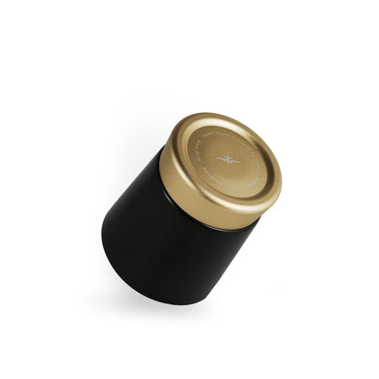 MHW-3BOMBER CERA black ceramic cup with gold metal base. Modern color-blocked design for espresso, lattes, and cappuccinos.