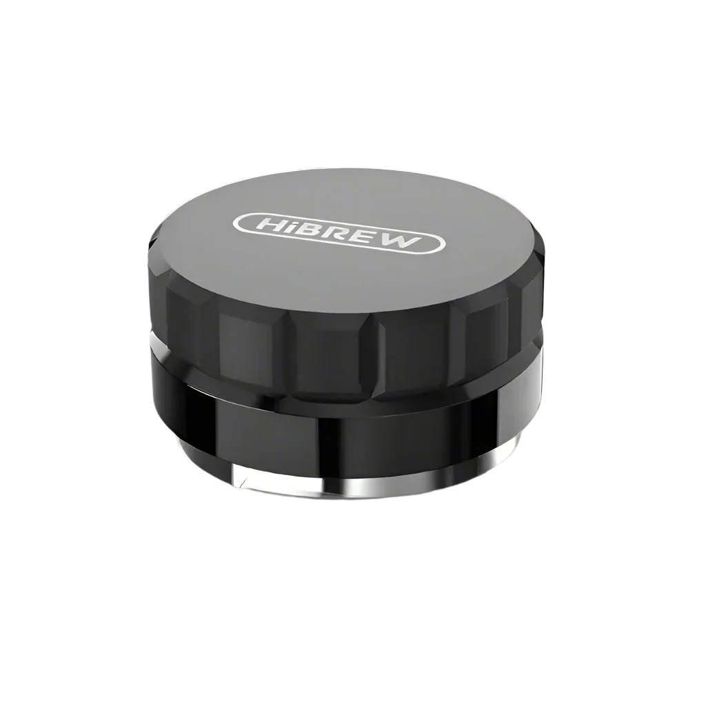 The HiBREW Coffee Distributor by Fix Coffee, a black and gray circular tamper with a textured grip, ensures even espresso extraction. Its smooth metallic bottom guarantees ideal tamping for your machine.