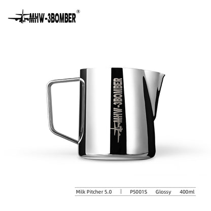 This 400ml silver MHW-3BOMBER Latte Art Pitcher 5.0 Glossy, made from glossy 304 stainless steel, features an etched MIW BOMBER logo on its side, a sturdy handle, and a crocodile spout for precise pouring.