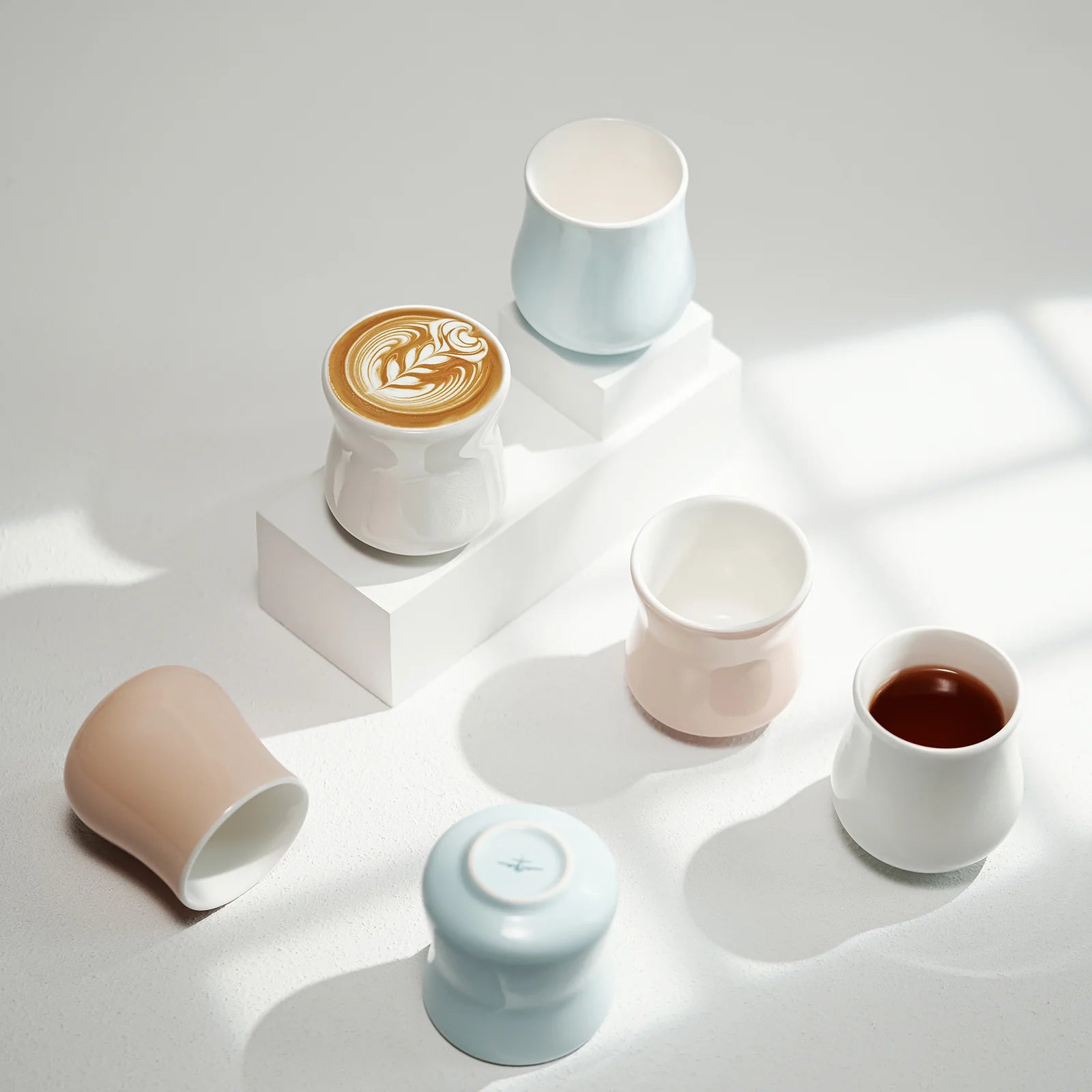 MHW-3BOMBER Aura ceramic cups in pastel colors. Coffee and tea in some cups.