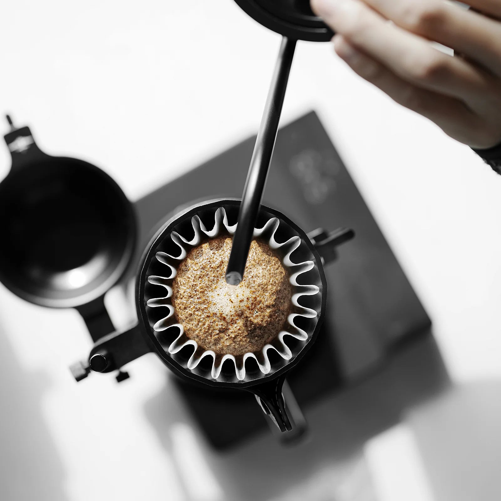 MHW-3BOMBER black Meteorite Dripper being used. Pour over coffee maker with unique rib design. 
