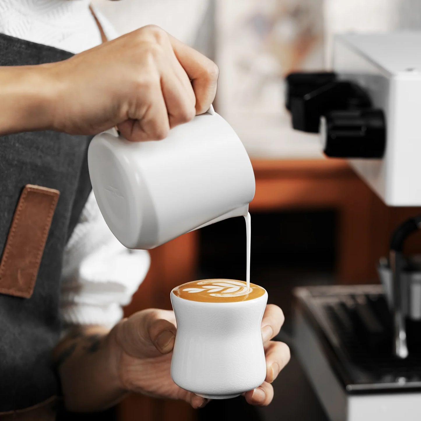 MHW-3BOMBER Aura ceramic cup. White cup being used to create latte art. 