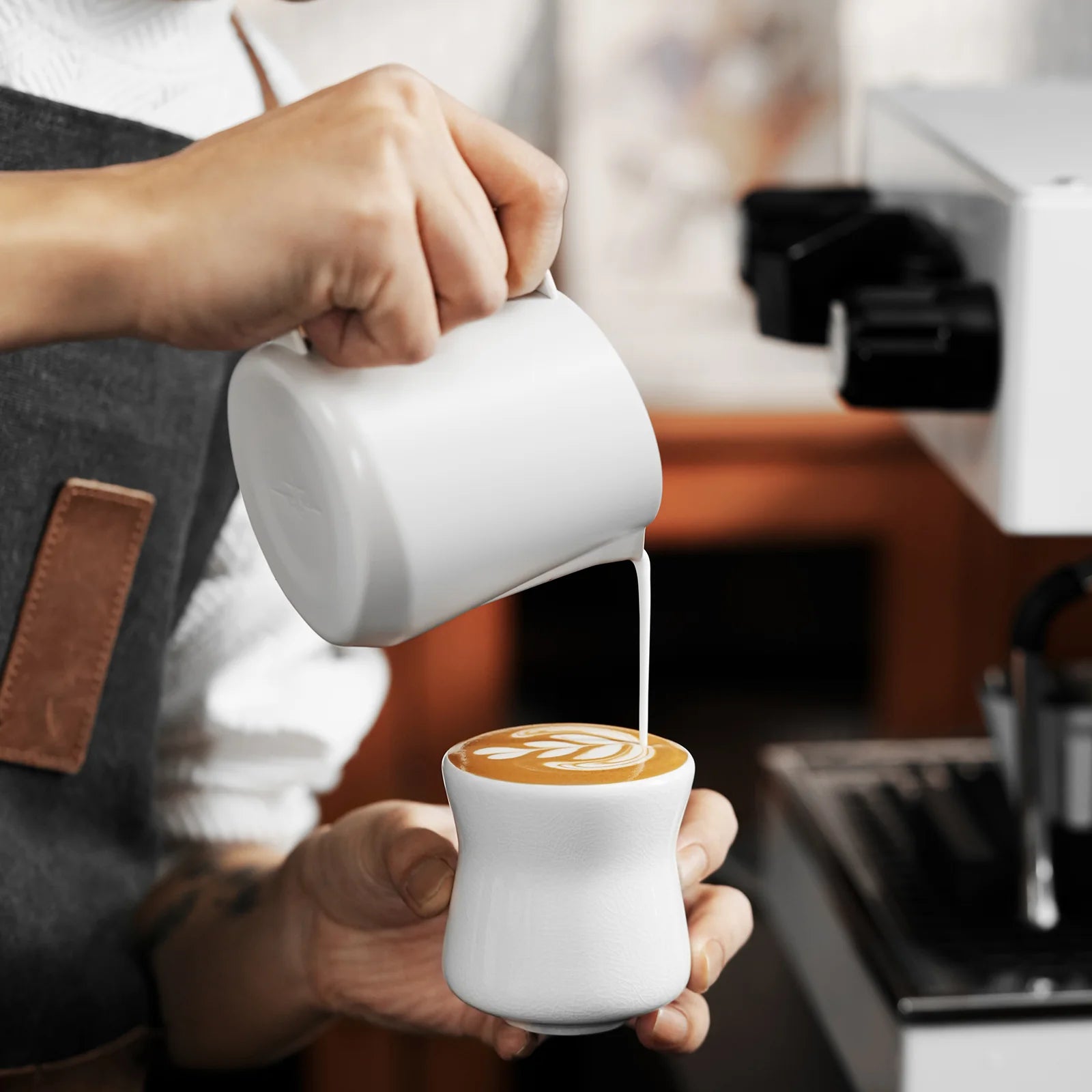 MHW-3BOMBER Aura ceramic cup. White cup being used to create latte art. 